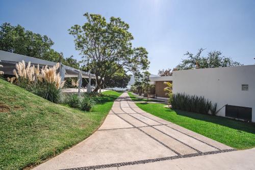 a walkway in front of a white building at Luxury Bungalow Lake view Cajititlan in Cajititlán