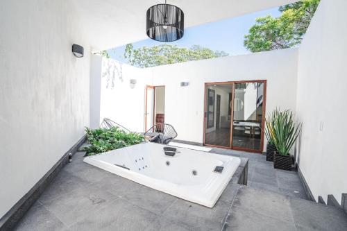 a bath tub in the middle of a room at Private Bungalow Cajititlan Pool in Cajititlán