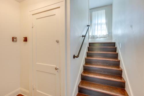 a stairway with a door and a stair case at Family-Friendly Independence Home 5 Mi to Stadium in Independence