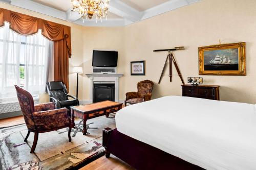 a bedroom with a bed and a tv and a fireplace at Best Western Merry Manor Inn in South Portland