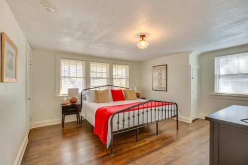 a bedroom with a bed with a red blanket at Family-Friendly Independence Home 5 Mi to Stadium in Independence