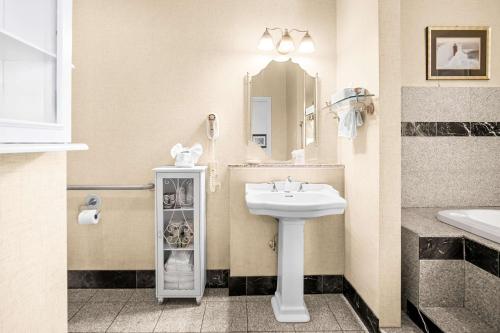a bathroom with a sink and a mirror at Best Western Merry Manor Inn in South Portland