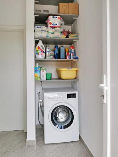 a laundry room with a washing machine in a closet at Apartment Kristijan in Šilo