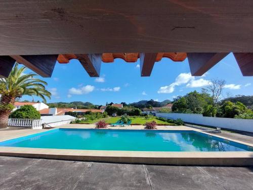 a large swimming pool under a pavilion at La Finca de Ananás - Suite privada con entrada independiente in Ponta Delgada