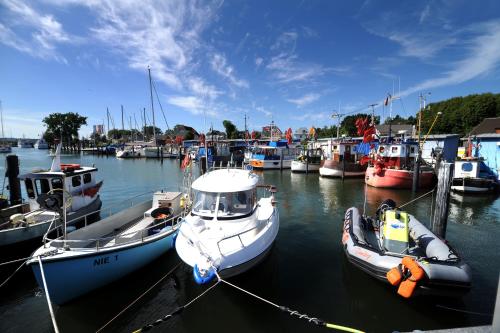 a group of boats are docked in a harbor at Strandhotel Luv in Timmendorfer Strand