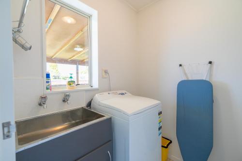 a small bathroom with a sink and a sinkiterator at Kepler Retreat - Te Anau Holiday Home in Te Anau