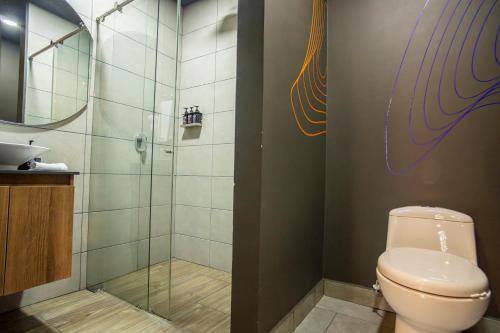 a bathroom with a toilet and a shower at Los Patios Cool Living in Medellín