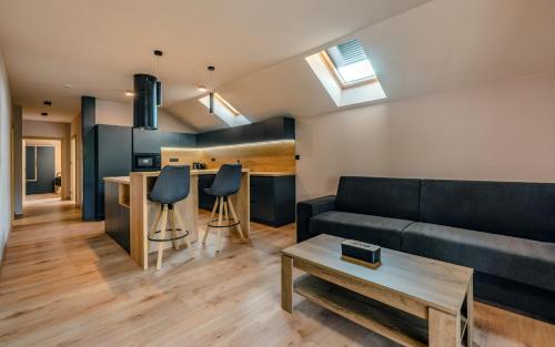 a living room with a couch and a table at Penzion U Mě in Obora
