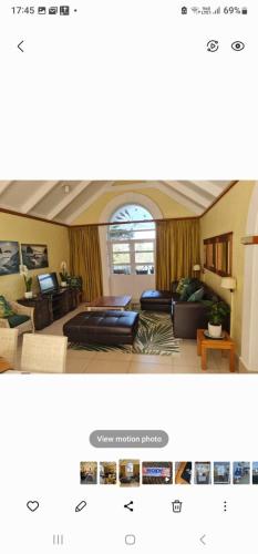 a living room with a couch and a table at Caribbean Estates Montego bay 30 in Port Edward