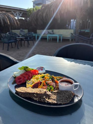 a plate of food on a table with a plate of food at Amanda beach hotel in Dahab