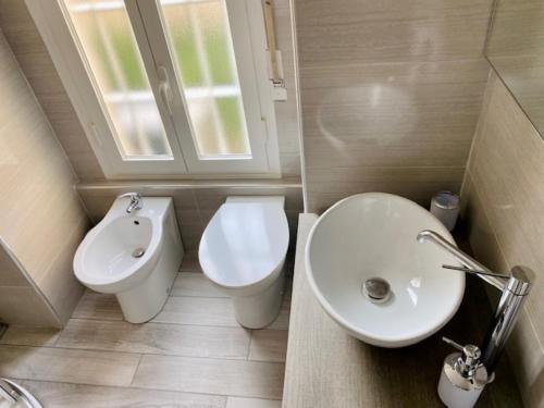 a bathroom with a toilet and a sink at Milan Cozy Apartment Gambara - SanSiro in Milan