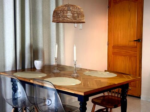 a dining room table with two candles and chairs at La Veranda Hotel & Restaurant in Minca