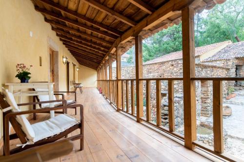 a large room with a wooden floor and windows at Quinta da Maria Mendes in Serpins