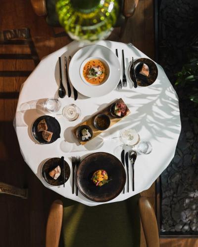 a table with plates of food on top of it at Scheiblhofer The Resort in Andau