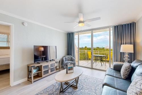 a living room with a couch and a tv at Sunrise Suites - Saint Kitts 412 in Key West