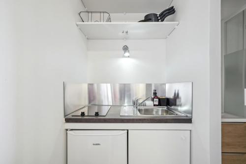 une cuisine avec un évier et un plan de travail dans l'établissement La Studette - Deux pas du quartier Gratte-Ciel, à Villeurbanne