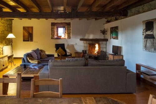 a living room with a couch and a fireplace at 4 bedrooms house, 4km from San Vicente beach in La Cotera
