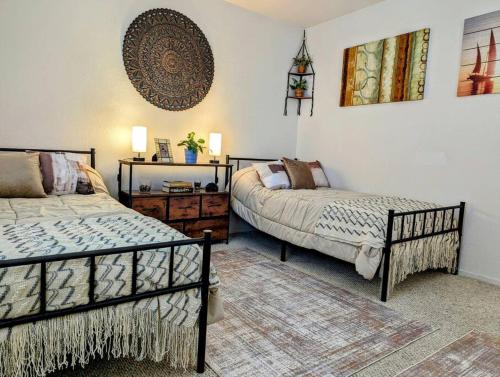 a bedroom with two beds and a dresser in it at 5 Minutes to South Bay Beaches! Private 2 bedroom 2 bath 2 level home with patio Excellent value! in Torrance
