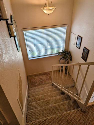 a staircase in a home with a window at 5 Minutes to South Bay Beaches! Private 2 bedroom 2 bath 2 level home with patio Excellent value! in Torrance