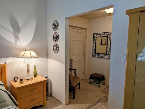 a living room with a bed and a table with a lamp at 5 Minutes to South Bay Beaches! Private 2 bedroom 2 bath 2 level home with patio Excellent value! in Torrance