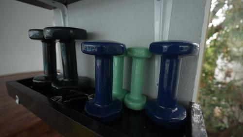 a shelf with four blue and green glass bottles at Royal Tulip Taj Sultan in Hammamet