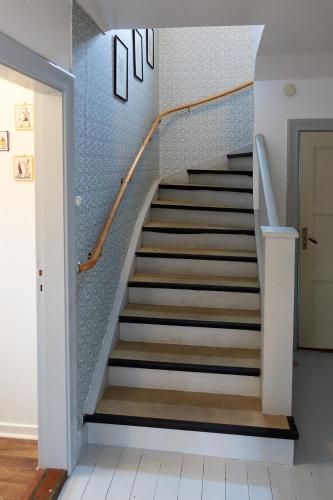 a staircase in a home with blue tiles at Fäbron house in Timbonäs