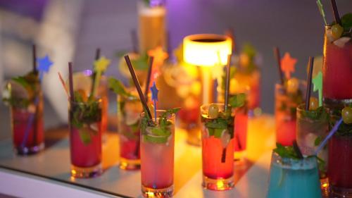a group of vases filled with drinks on a table at Royal Tulip Taj Sultan in Hammamet