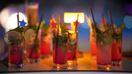 a group of four vases filled with drinks on a table at Royal Tulip Taj Sultan in Hammamet