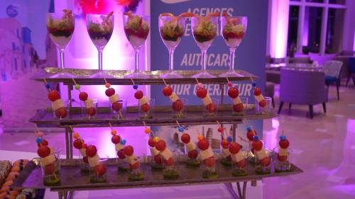 a display of desserts and wine glasses on a table at Royal Tulip Taj Sultan in Hammamet