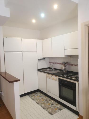 a kitchen with white cabinets and a stove top oven at Residence Vanvitelli in Ancona