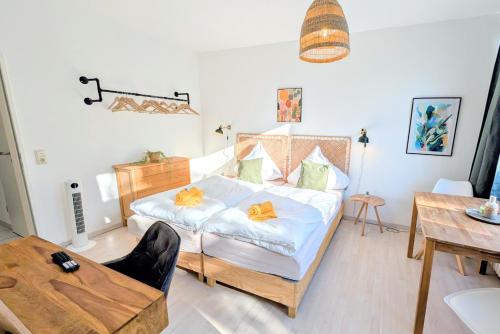 a bedroom with a bed with orange bows on it at Uhlpartment - im Herzen von Munster in Munster im Heidekreis