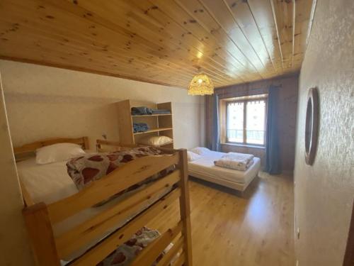 une chambre avec deux lits et une fenêtre dans l'établissement Eric 1, à Val Cenis