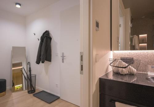 a bathroom with a counter and a sink and a mirror at Luxusapartment Golden Garden in Sindelfingen