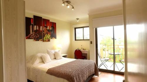 a bedroom with a bed and a balcony at Hotel San Fernando in San Fernando