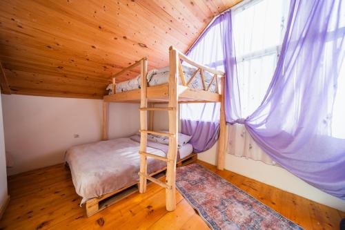 a bedroom with a bunk bed in a tree house at Happy days house in Shuakhevi