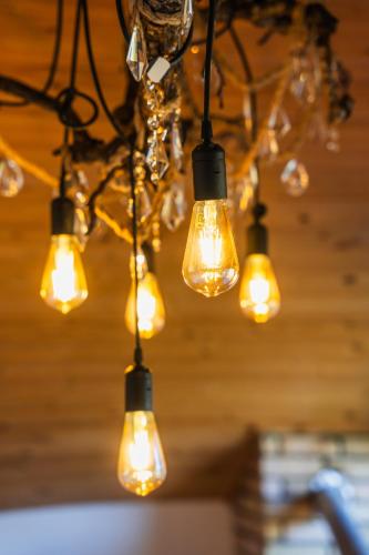 a bunch of lights hanging from a ceiling at Happy days house in Shuakhevi