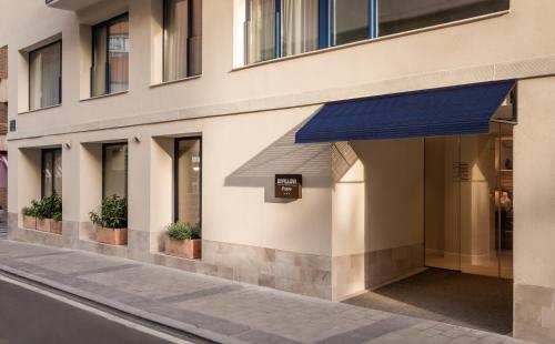 a facade of a building with a blue awning at BYPILLOW Paseo in Alicante