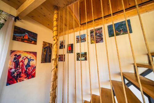 a room with a bunch of pictures on the wall at Happy days house in Shuakhevi