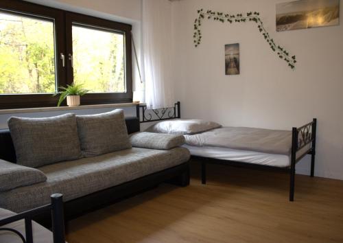 a living room with a couch and a bed at Traumhafte Ferienwohnung Andechs in Andechs