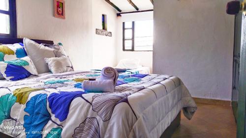 a bedroom with a large bed with a towel on it at La tranquera hotel in Villa de Leyva