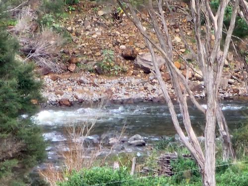 a stream of water with rocks in the middle at Thames River Valley Studio Retreat 1 in Thames