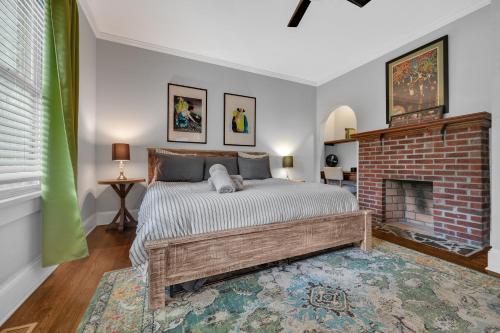 a bedroom with a bed and a brick fireplace at 1920s Bungalow with King bed WIFI Fenced backyard in Atlanta