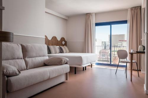 a living room with a couch and a bed at BYPILLOW Paseo in Alicante