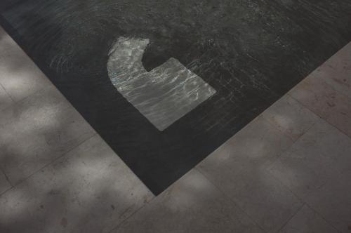 a reflection of a metal object on a floor at SOKO' Stay at Kedungu in Tanah Lot