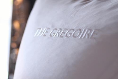 a white shirt with theorema written on it at The Gregoire Boutique Villa in Hermanus