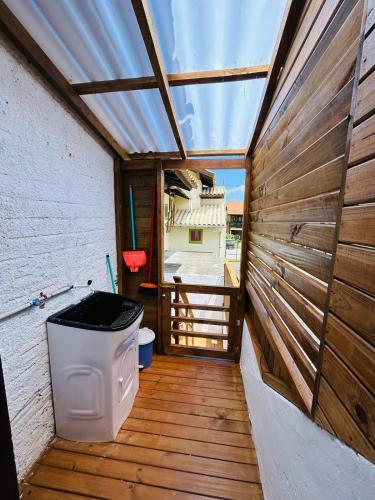 a wooden deck with a toilet in a building at Ap pé na areia praia Garopaba in Garopaba