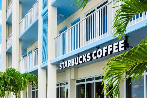 a building with a starbucks coffee sign on it at Blue Flamingo Resort Key West in Key West