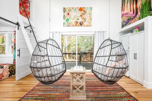 two hanging baskets in a room with a rug at Full Bloom Tree House in Pittsboro