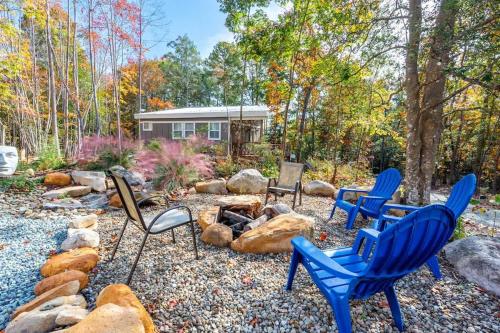 a group of chairs sitting around a fire pit at Two Tree Houses - Galaxy & Full Bloom in Pittsboro