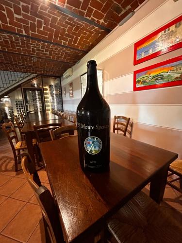 a bottle of wine sitting on a table in a restaurant at Agriturismo Tre Tigli in Asti